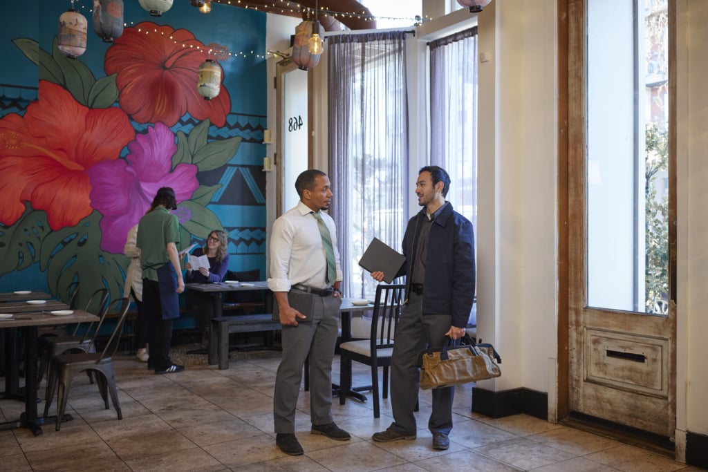 Provider speaking to restaurant owner about asset management.