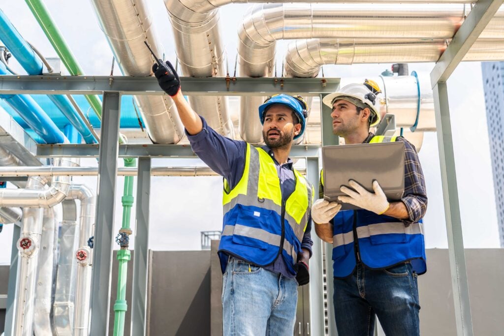 construction-workers-reviewing-blueprints-on-a-rooftop