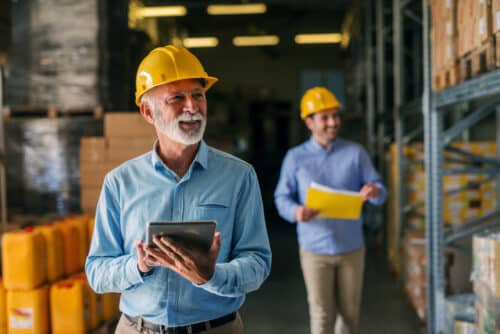 Two members of real estate and construction team with tablets.