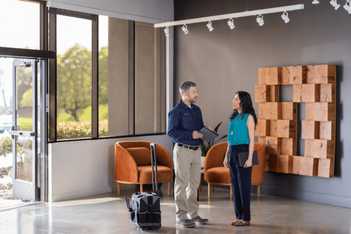 Construction team member meets with facilities team member at the medical office entrance.