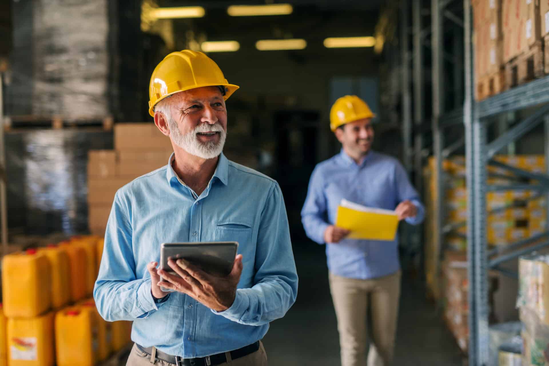 Two members of real estate and construction team with tablets.
