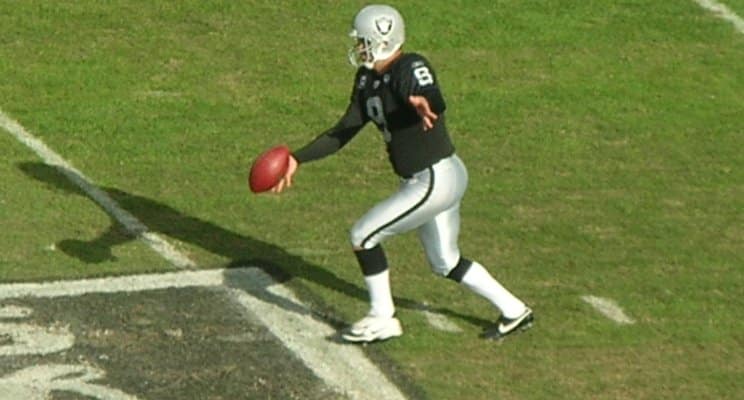 footplayer preparing to punt the football