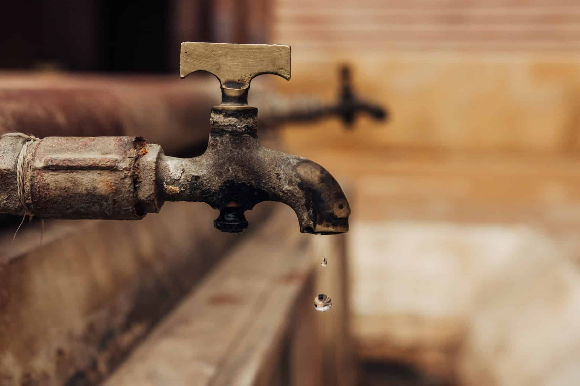 water drop falling from old tap