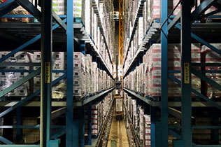 rows of product stacked on towering blue warehouse storage racks