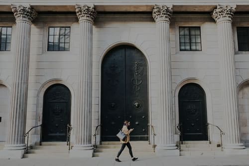 woman walking in front of medical institution