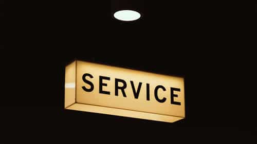 rectangular sign lit up in the dark saying "service"