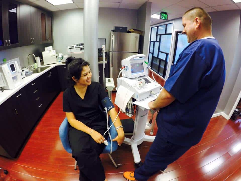 professional nurse receiving diagnostic blood pressure test