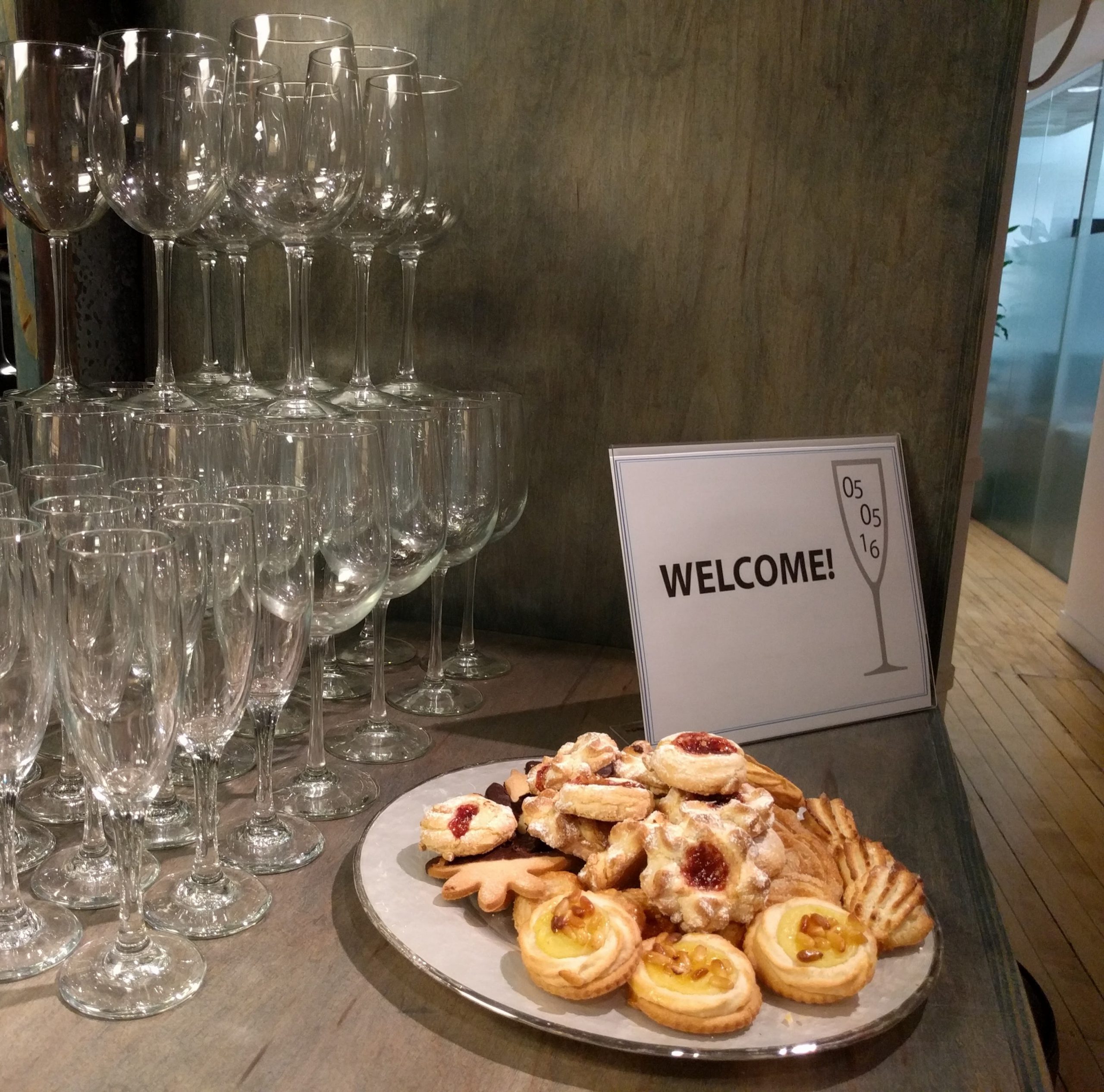 plate of pastries with pyramid of champagne glasses