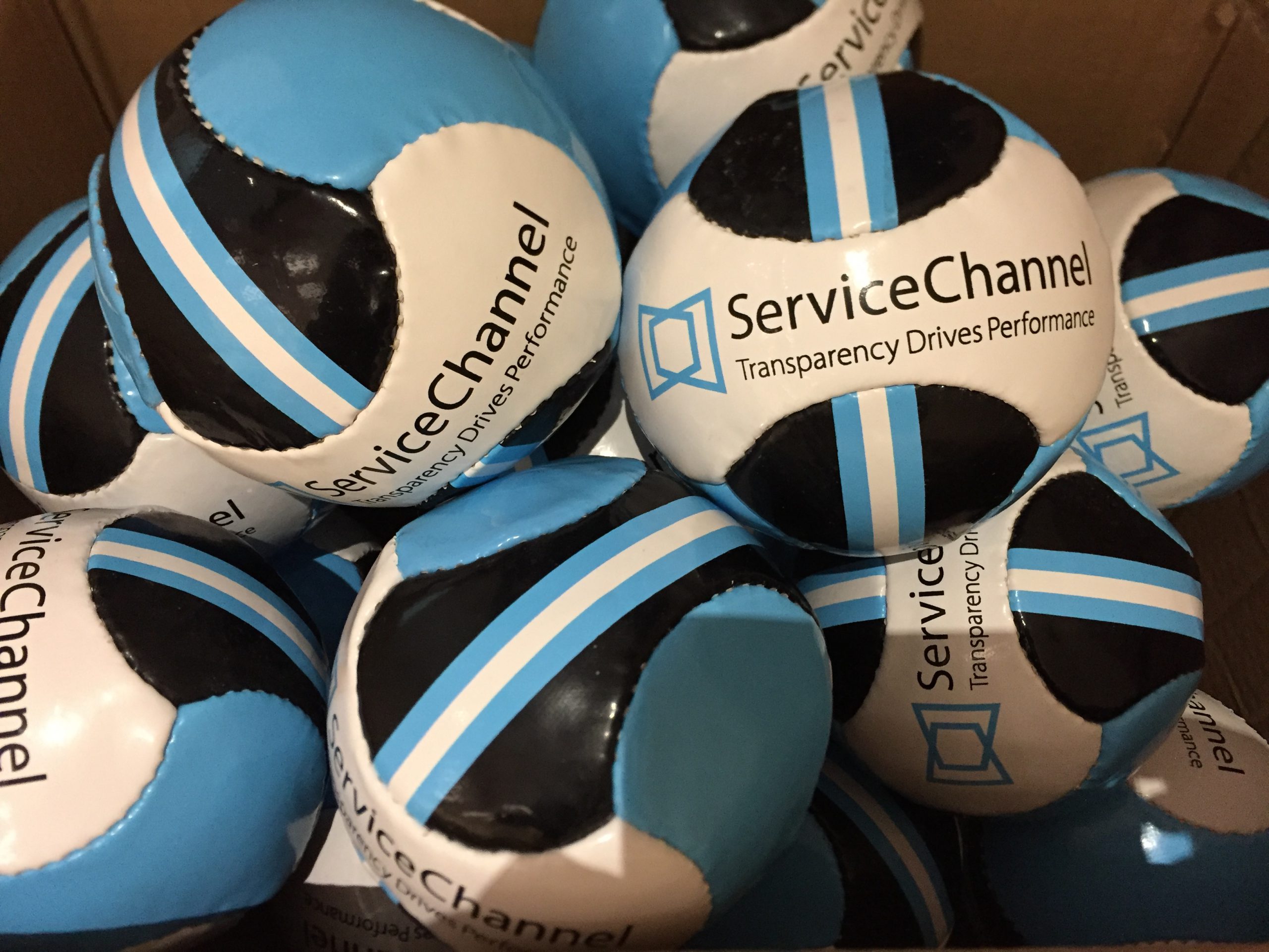 ServiceChannel branded sport balls in a pile