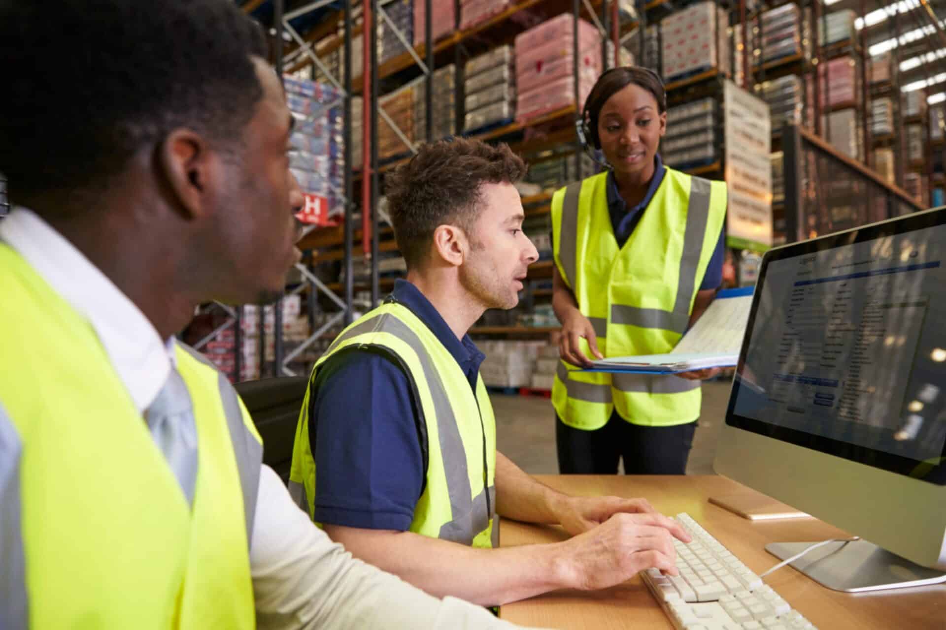 site workers gathered around a desktop to review form submission information