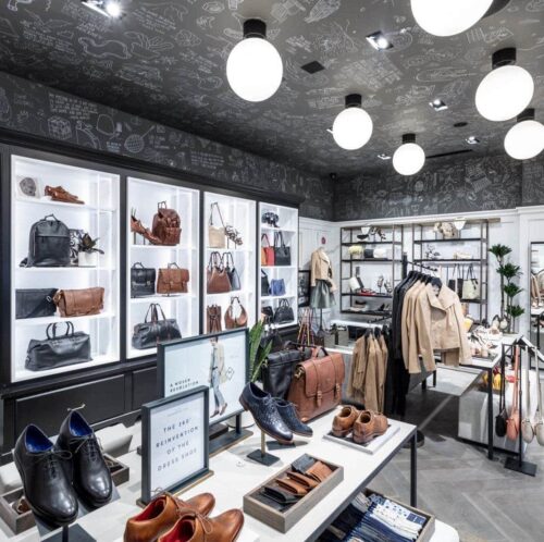 cole haan store interior with various bags, shoes, and jackets on display