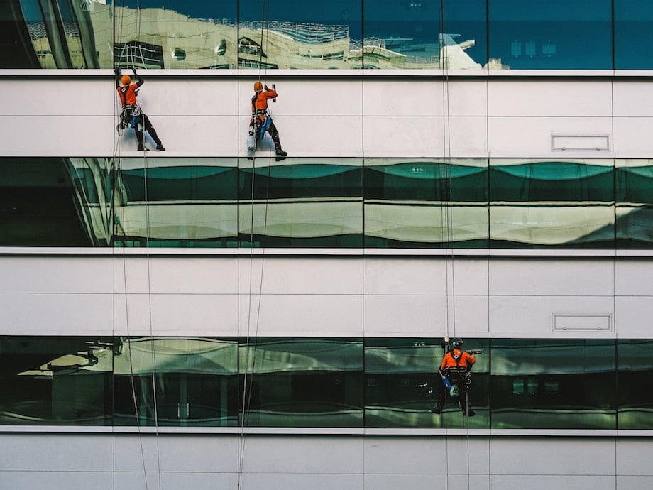 window washing professionals scaling the side of a building
