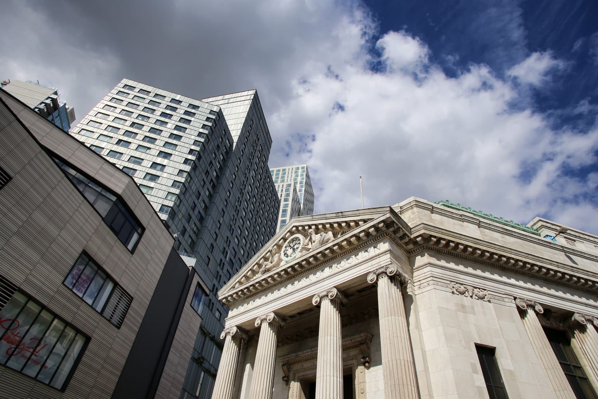 looking up towards towering buildings in a downtown financial district