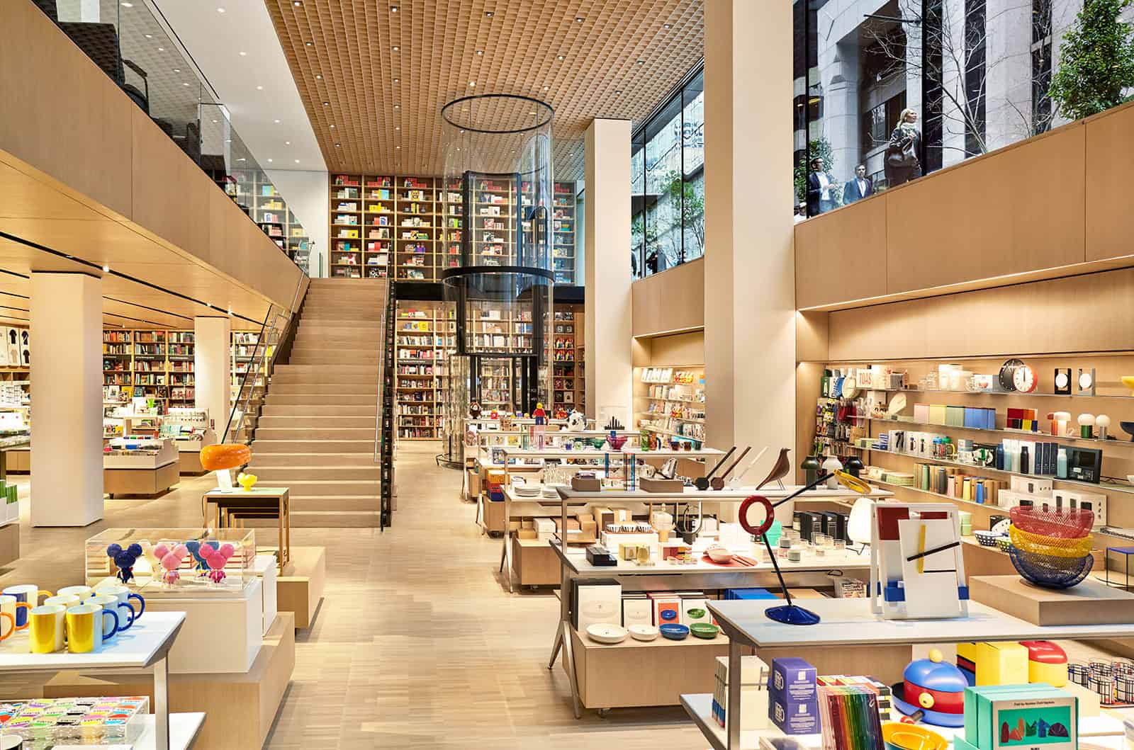 generic bookstore with bookcases filled with books and tables displaying various knick knacks and office supplies