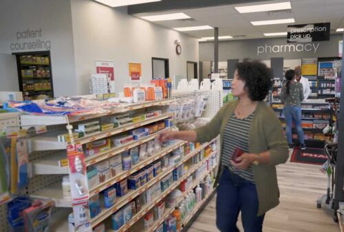 generic pharmacy interior with various customers inside