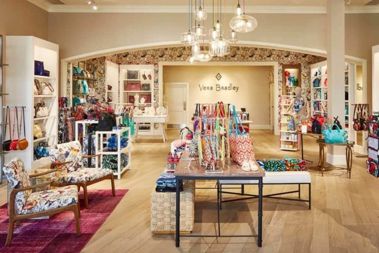 Vera Bradley store interior with various bags on shelves and tables on display