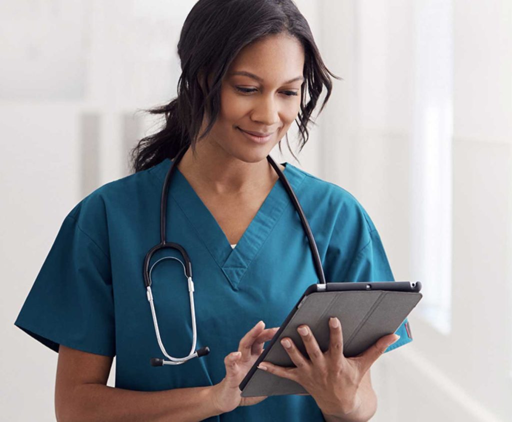 young healthcare professional reviewing information on her tablet
