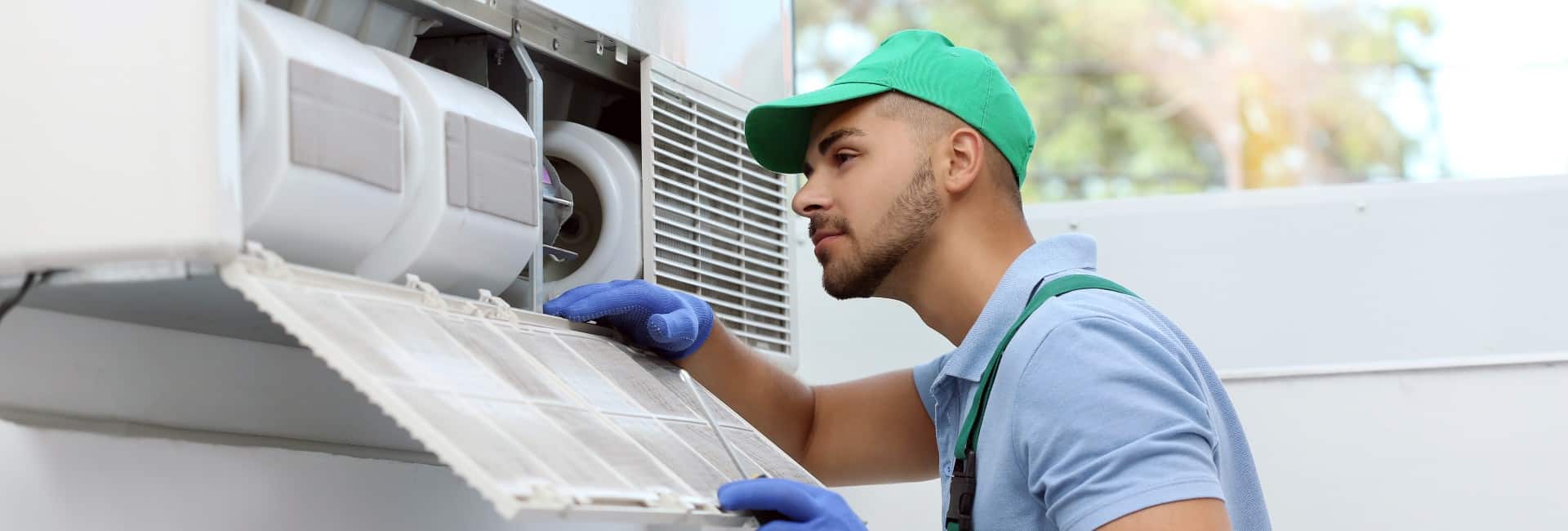 Construction Worker On-Site Repairing condensor