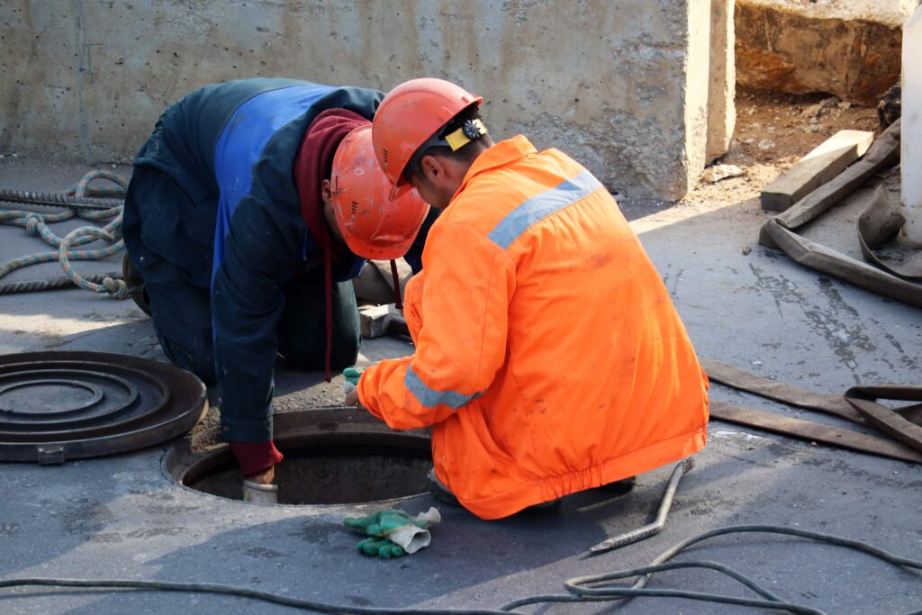 workers servicing and maintaining sewer lines