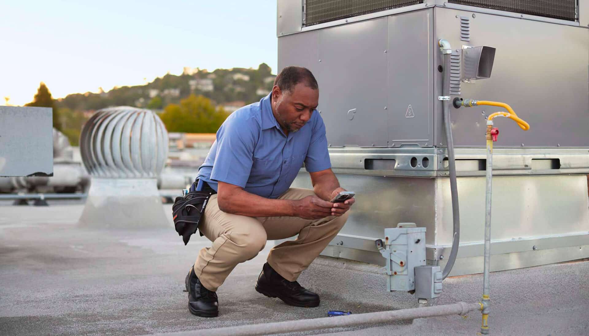 AI-trained tech inspecting HVAC unit.